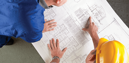 two engineers pouring over their drawings