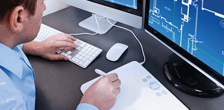 Man using a computer, keyboard and tablet for his engineering project