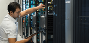 audio visual technician servicing an equipment rack