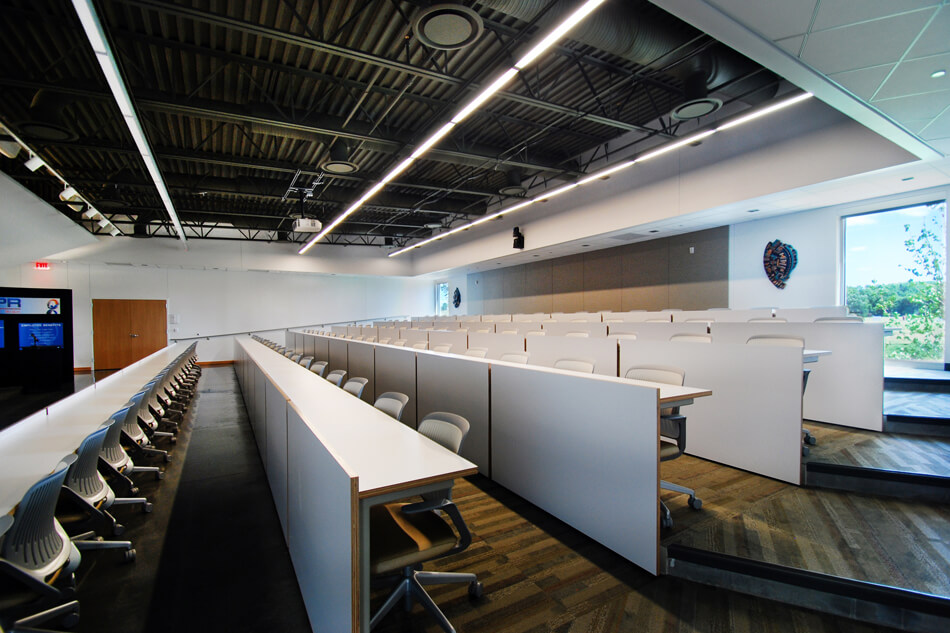 multipurpose room with five rows of seating and a projector