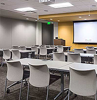 classroom with podium, retractable screen and a projector