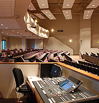church audio visual table with sound board, a monitor and stereo