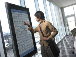 student looks at smart kiosk, interactive guide