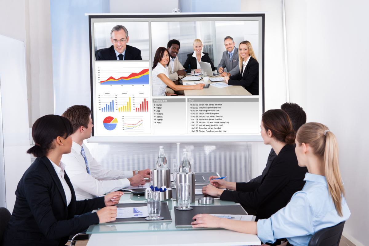 Businesspeople In Video Conference At Business Meeting Businesspeople Sitting In A Conference Room Looking At Screen, virtual meeting
