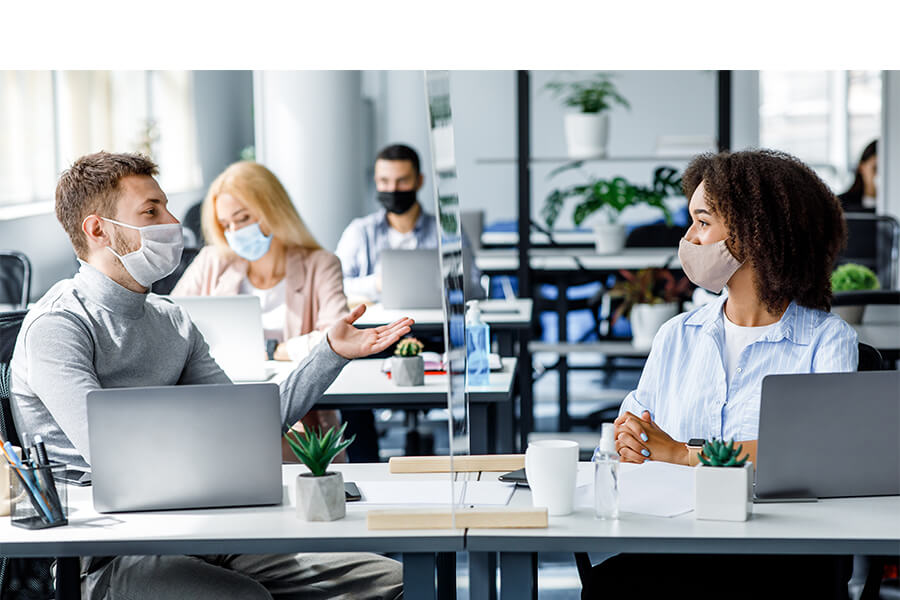 people wearing masks working in office
