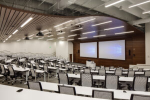 Education wavy ceiling classroom with dual monitors and a projector