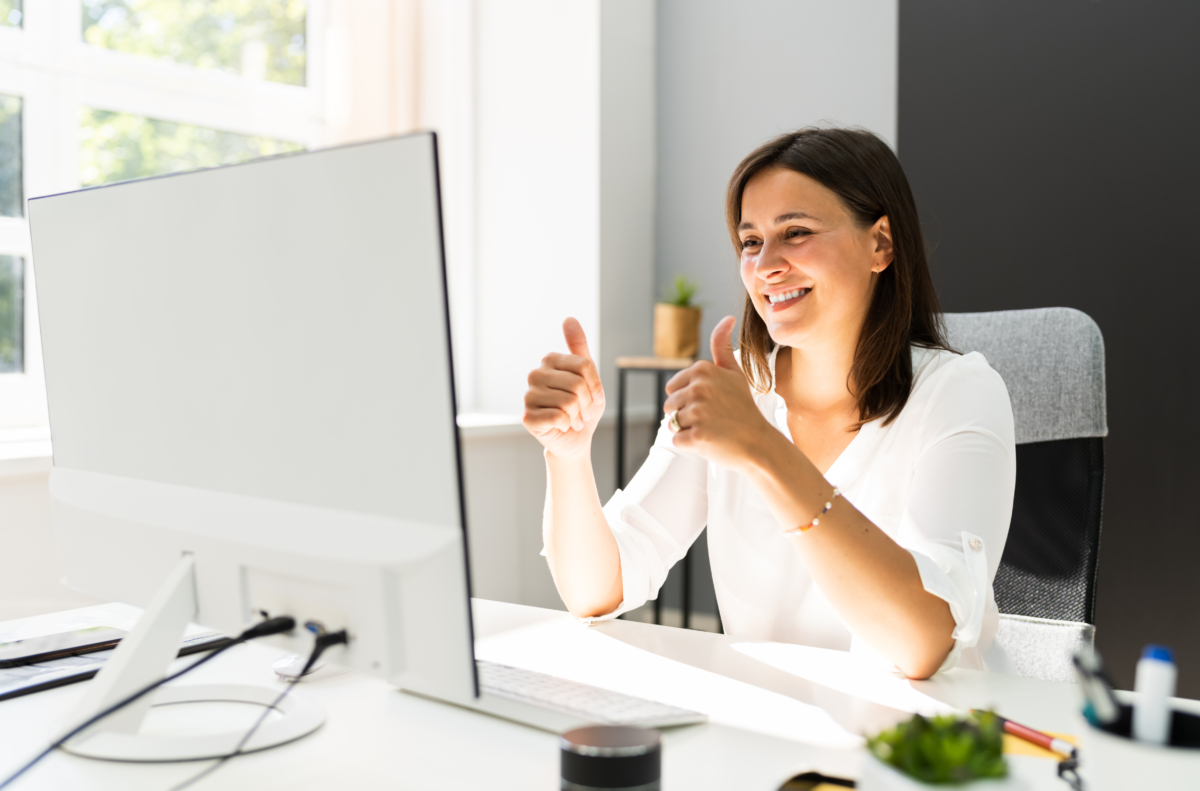 women in conference giving 2 thumbs up